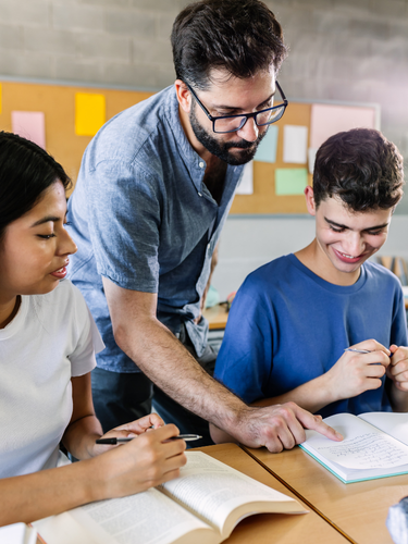 Teacher helping students read